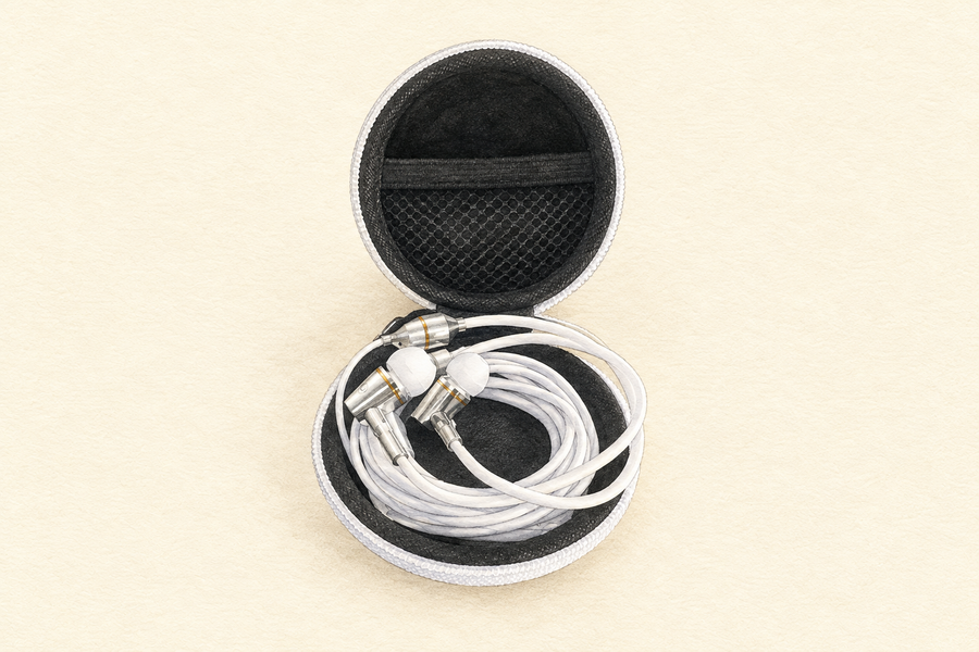 3.5 mm headphones resting in the open included case before tucking in the tubes